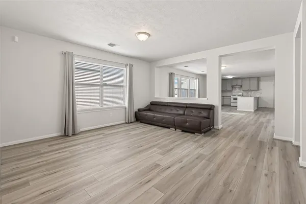a large room with wooden floor and windows
