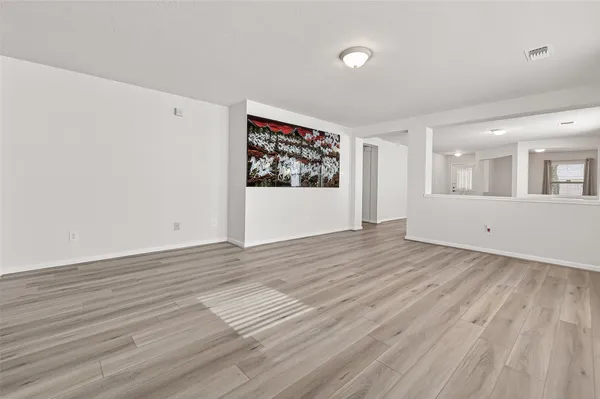 a view of a room with wooden floor and window