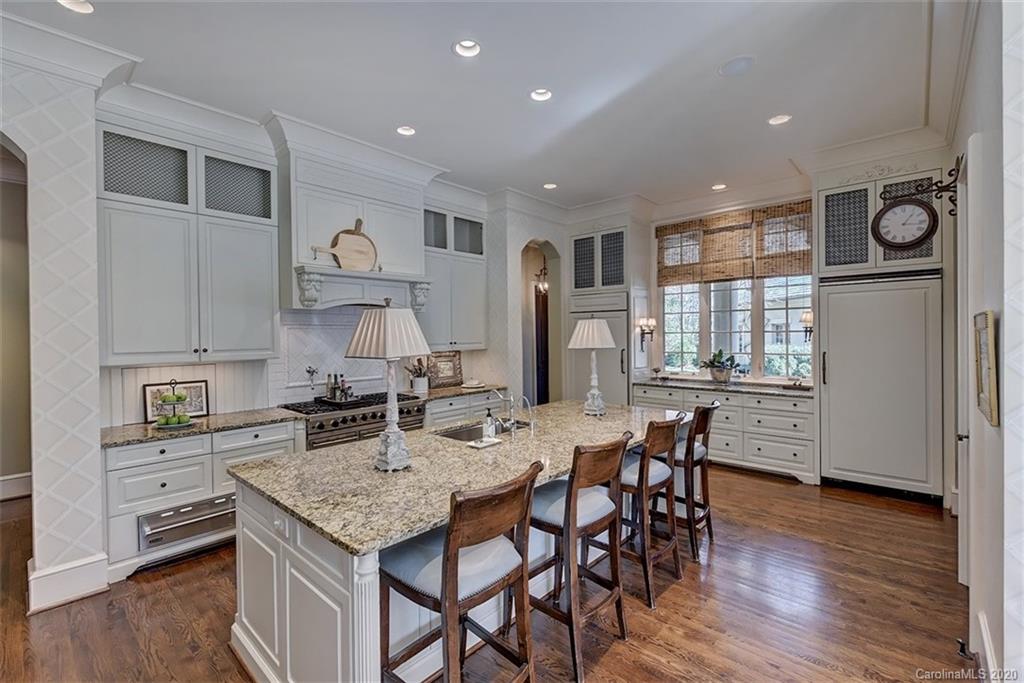 6256 Sharon Hills Road Charlotte, NC 28210 - Photo 13 of 45 a kitchen with granite countertop a stove a sink a refrigerator dining table and chairs