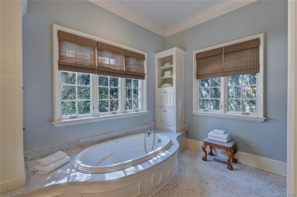 6256 Sharon Hills Road Charlotte, NC 28210 - Photo 21 of 45 a bath tub sitting in a bathroom next to a window
