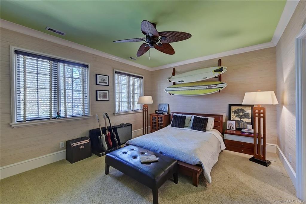 6256 Sharon Hills Road Charlotte, NC 28210 - Photo 30 of 45 a bed room with a bed and a chandelier