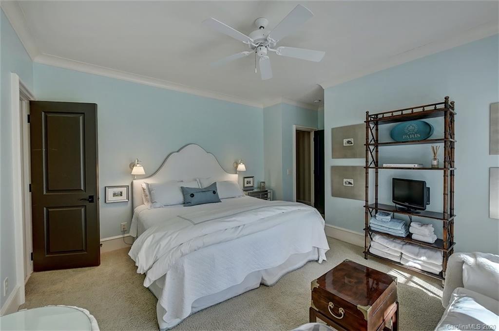 6256 Sharon Hills Road Charlotte, NC 28210 - Photo 34 of 45 a bedroom with a bed and a television