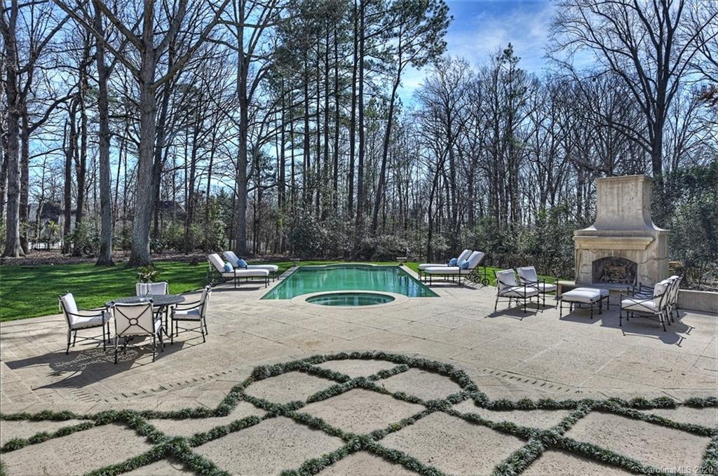 6256 Sharon Hills Road Charlotte, NC 28210 - Photo 38 of 45 a view of a backyard with a bench and a fire pit