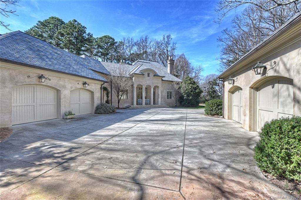 6256 Sharon Hills Road Charlotte, NC 28210 - Photo 44 of 45 a view of a white house with a large tree and wooden fence