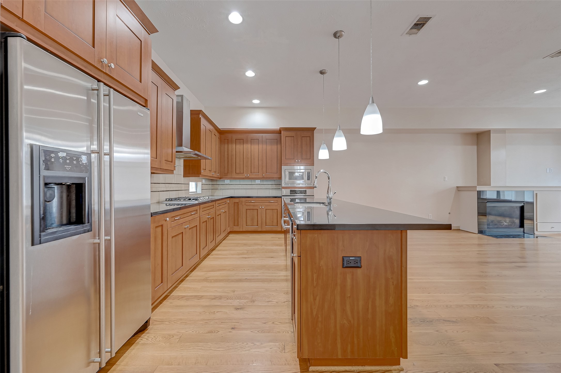 5315 Lillian Street Houston, TX 77007 - Photo 15 of 47 a large kitchen with stainless steel appliances kitchen island a large counter top and a wooden floors