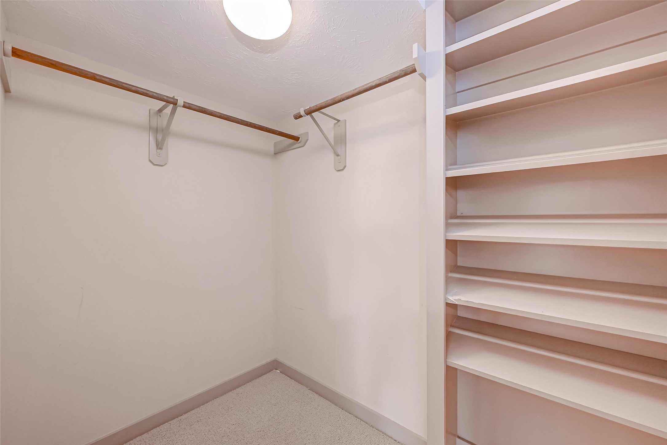 5315 Lillian Street Houston, TX 77007 - Photo 24 of 47 a view of walk in closet with empty racks