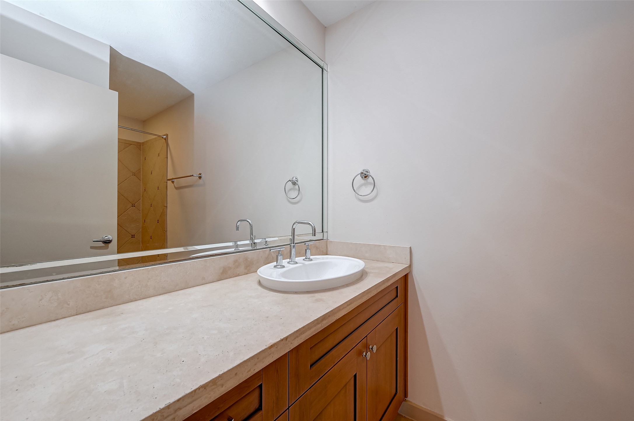 5315 Lillian Street Houston, TX 77007 - Photo 25 of 47 a bathroom with a granite countertop sink and a mirror