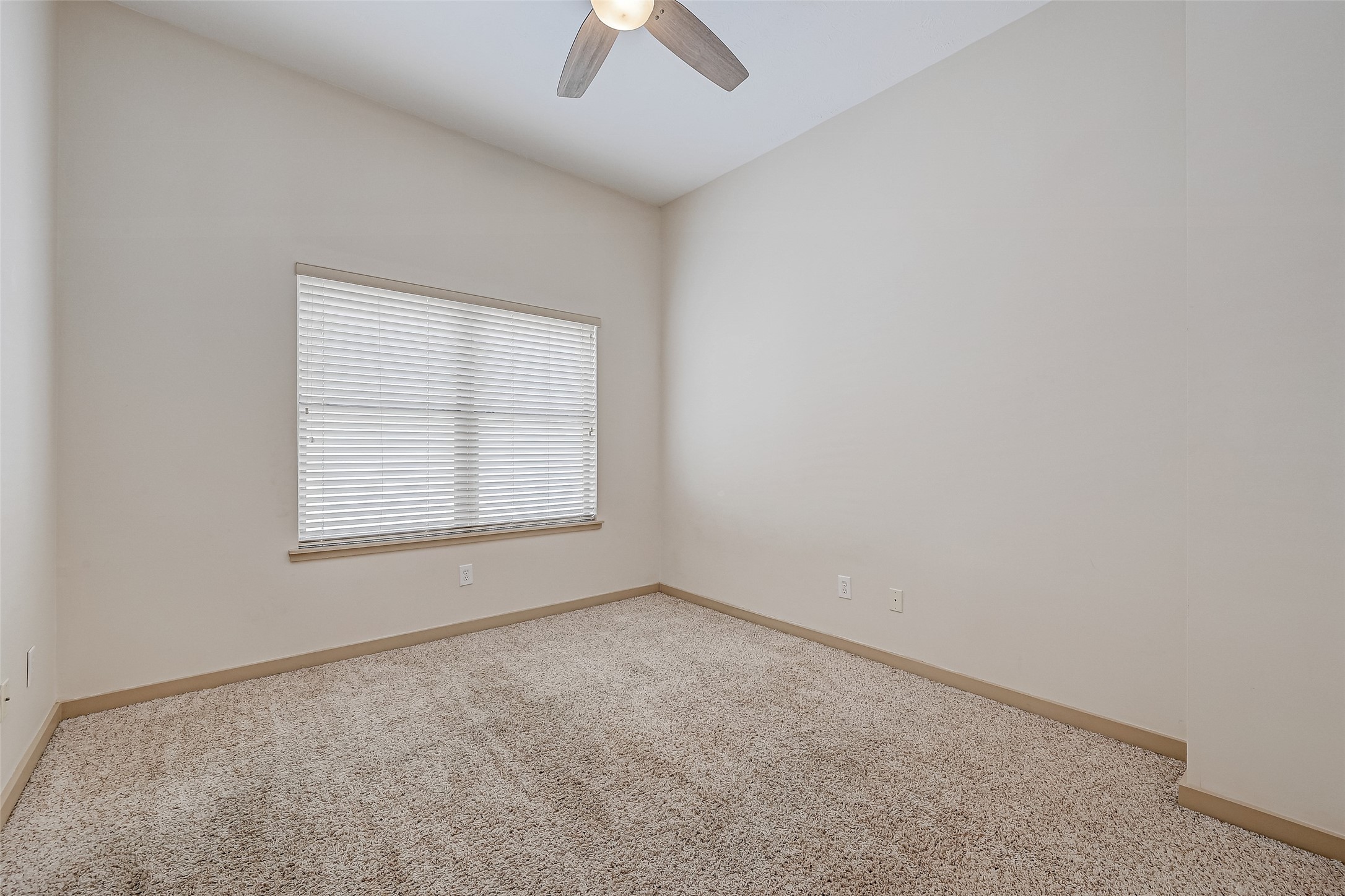 5315 Lillian Street Houston, TX 77007 - Photo 27 of 47 an empty room with a window and a fan