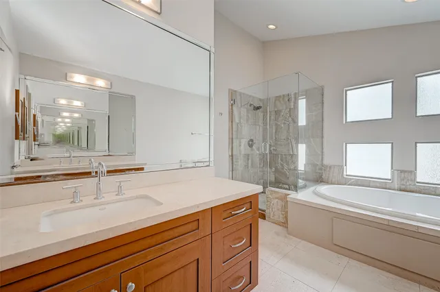 a spacious bathroom with a bathtub and a sink