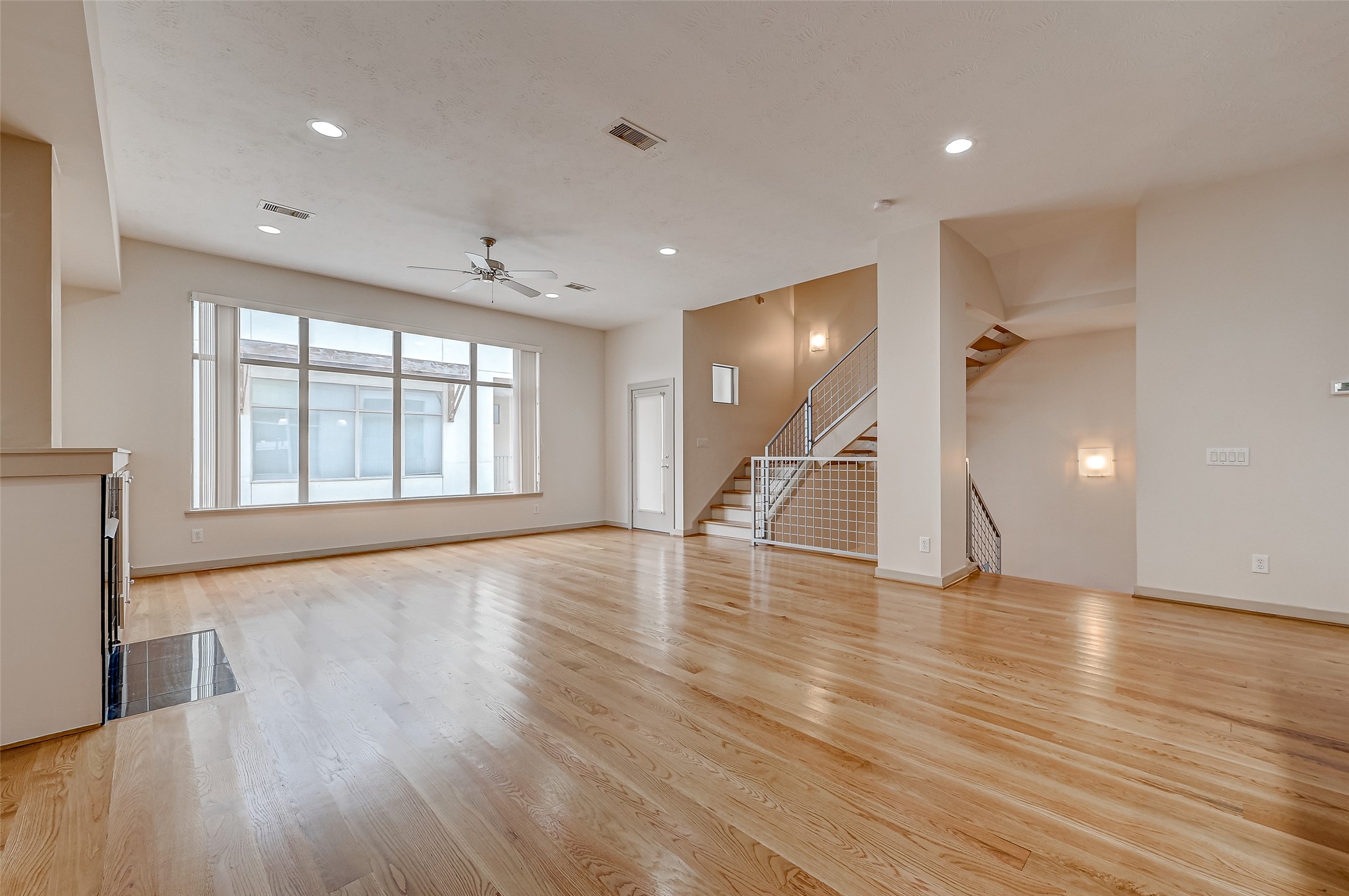 5315 Lillian Street Houston, TX 77007 - Photo 7 of 47 a view of an empty room with wooden floor and a window
