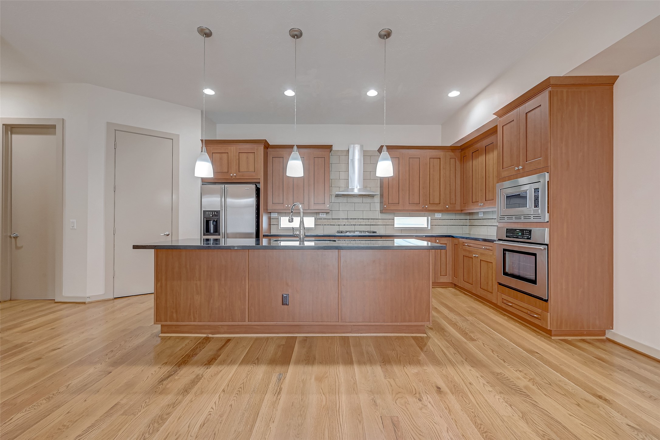 5315 Lillian Street Houston, TX 77007 - Photo 10 of 47 a kitchen with granite countertop a stove top oven and cabinets