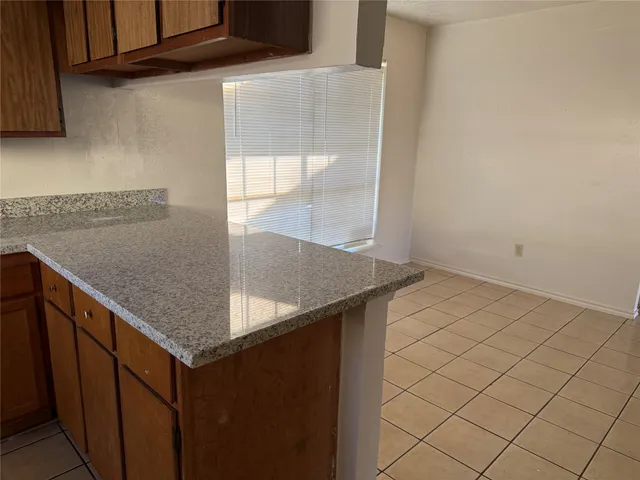 a kitchen with a sink a refrigerator and window
