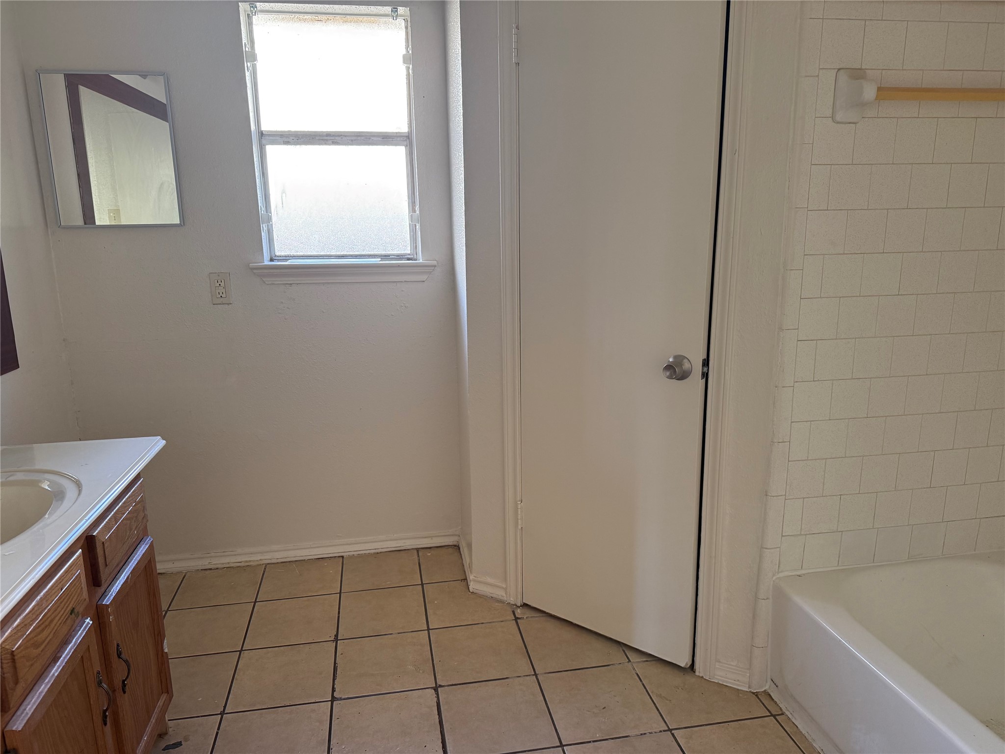 2114 West Greens Road Houston, TX 77067 - Photo 15 of 16 a bathroom with a bathtub and window