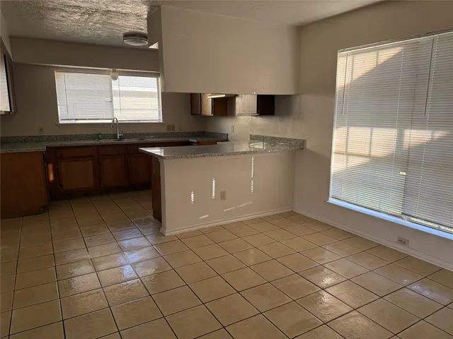 a kitchen with stainless steel appliances granite countertop a sink and a stove
