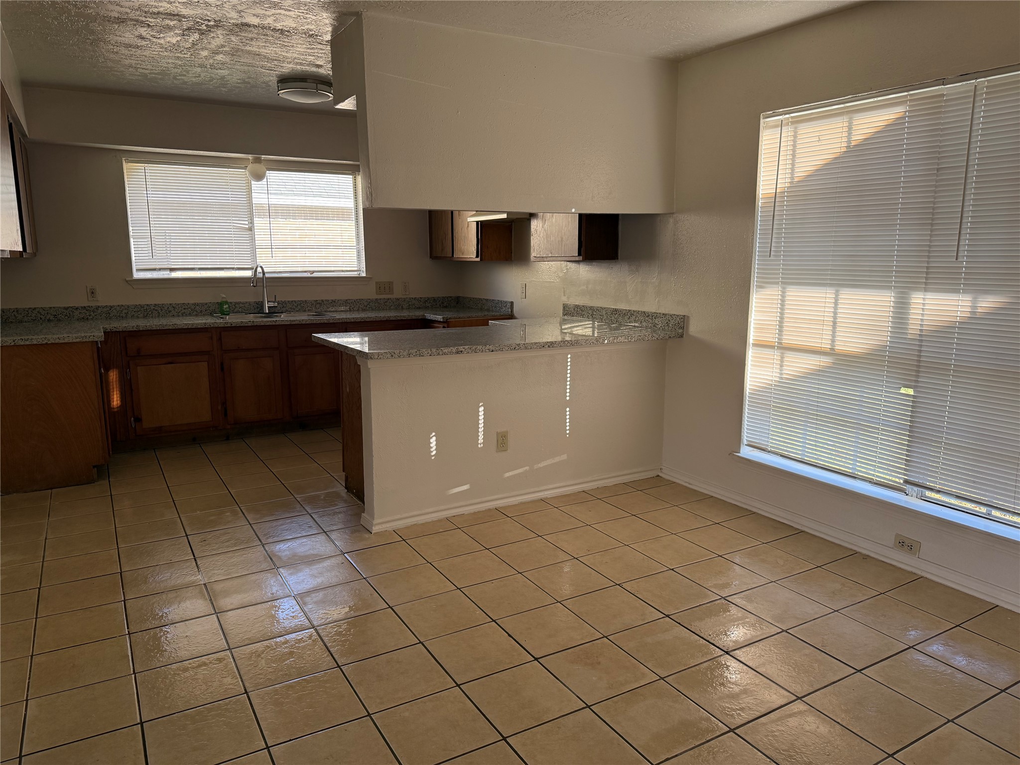 2114 West Greens Road Houston, TX 77067 - Photo 4 of 16 a kitchen with stainless steel appliances granite countertop a sink and a stove