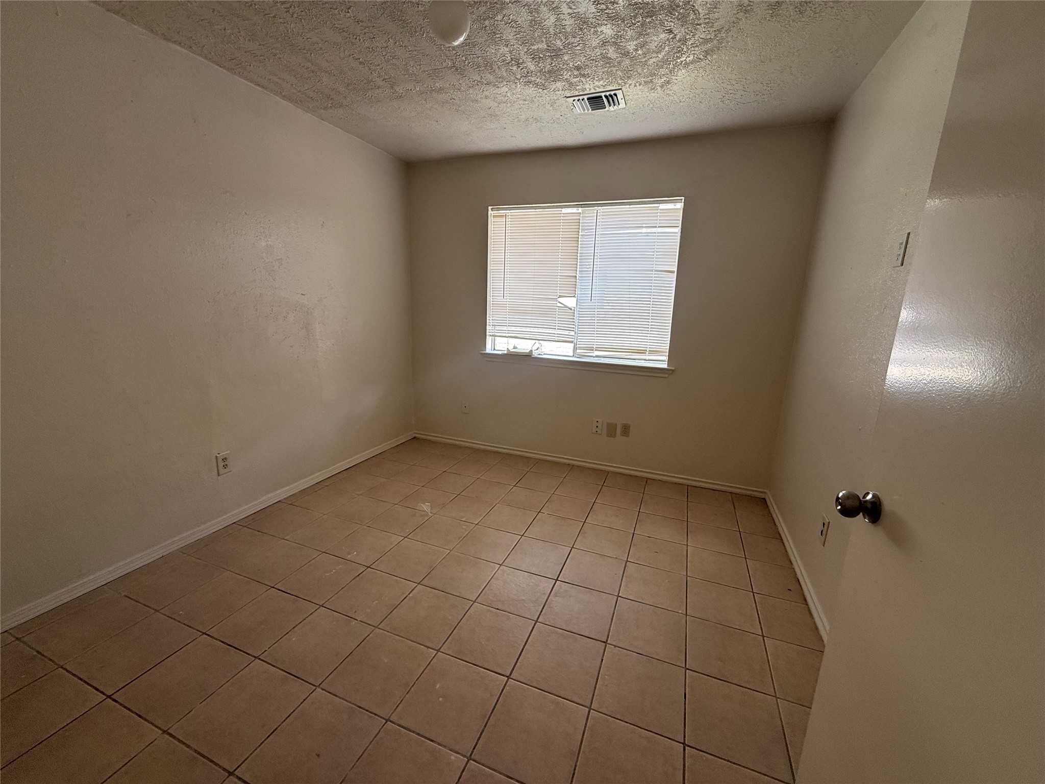 2114 West Greens Road Houston, TX 77067 - Photo 8 of 16 an empty room with a empty space and a window