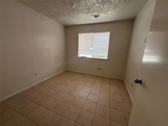 an empty room with a empty space and a window