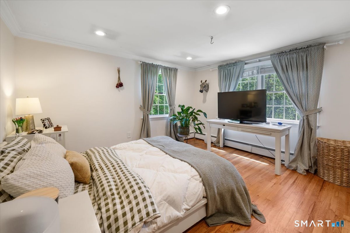94 Vista Road Wilton, CT 06897 - Photo 28 of 38 a bedroom with a bed and a flat screen tv