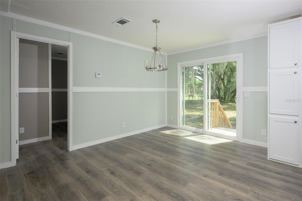 374 Sisco Road Pomona Park, FL 32181 - Photo 11 of 40 an empty room with wooden floor and windows