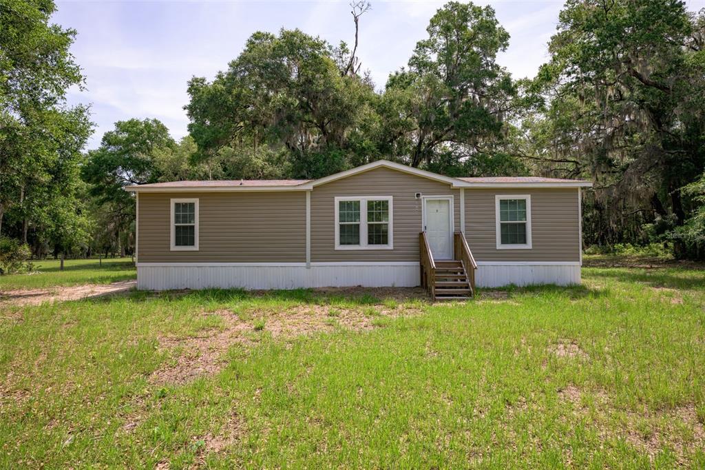 374 Sisco Road Pomona Park, FL 32181 - Photo 2 of 40 a view of a house with backyard