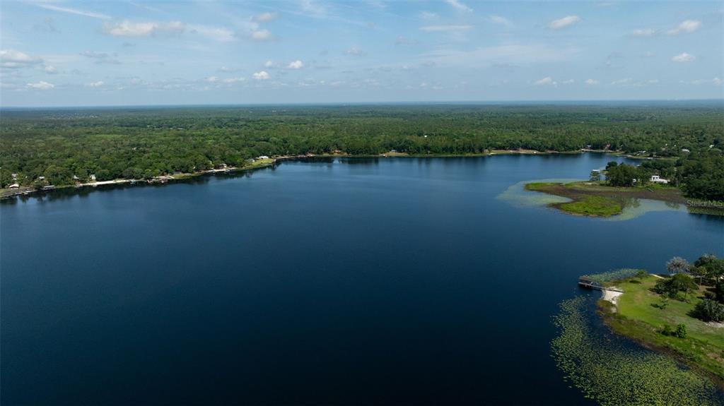 374 Sisco Road Pomona Park, FL 32181 - Photo 35 of 40 a view of a lake with houses in the back