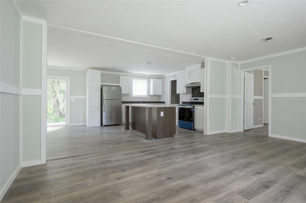 374 Sisco Road Pomona Park, FL 32181 - Photo 4 of 40 a large kitchen with stainless steel appliances granite countertop a stove and a refrigerator
