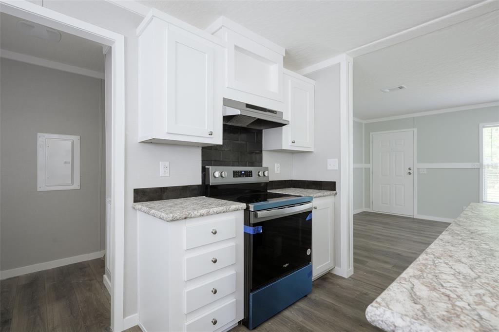 374 Sisco Road Pomona Park, FL 32181 - Photo 10 of 40 a kitchen with stainless steel appliances granite countertop a stove and a sink