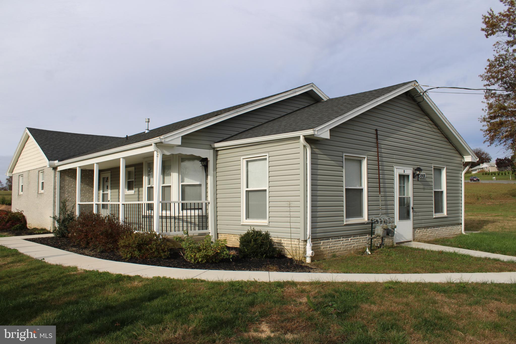 490 Windsor Street, Unit B Red Lion, PA 17356 - Photo 1 of 15 a front view of a house with a yard and plants