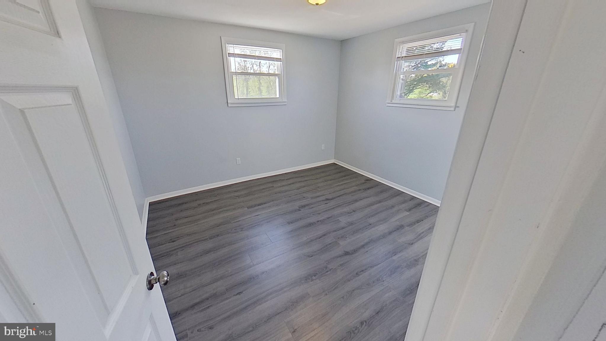 490 Windsor Street, Unit B Red Lion, PA 17356 - Photo 11 of 15 a view of an empty room with wooden floor and a window