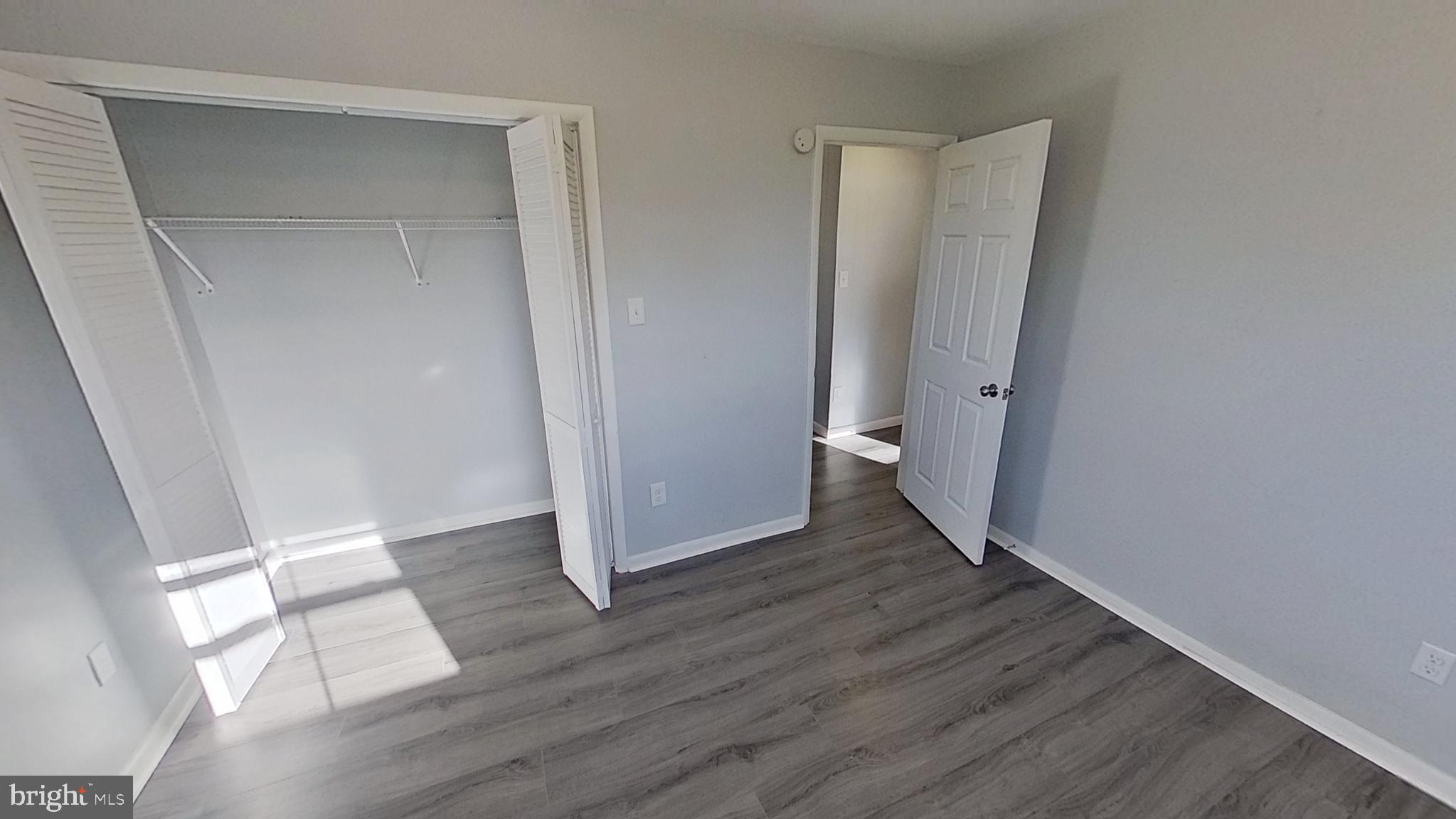 490 Windsor Street, Unit B Red Lion, PA 17356 - Photo 12 of 15 an empty room with wooden floor and a window