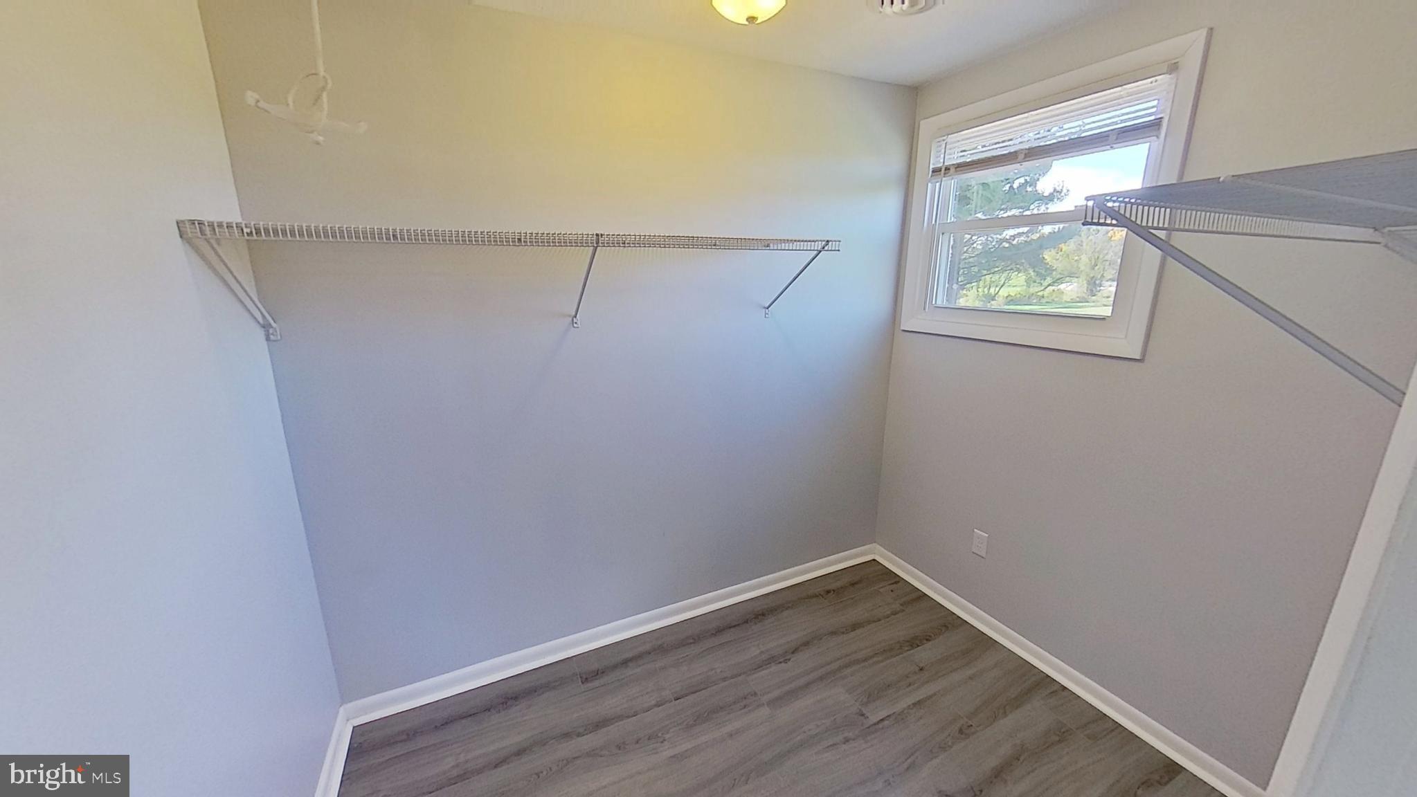 490 Windsor Street, Unit B Red Lion, PA 17356 - Photo 14 of 15 a view of an empty room with wooden floor and a window