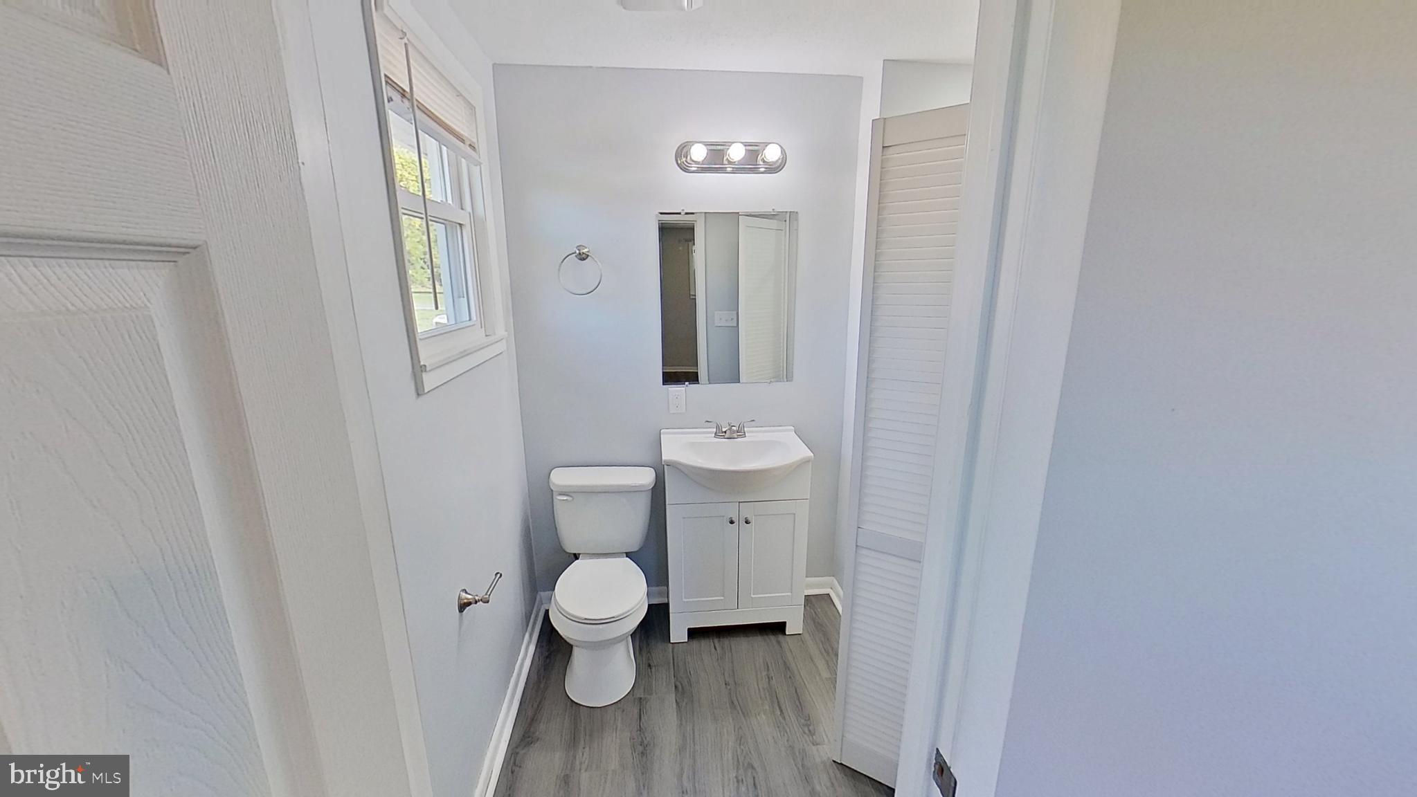 490 Windsor Street, Unit B Red Lion, PA 17356 - Photo 15 of 15 a bathroom with a toilet sink and mirror