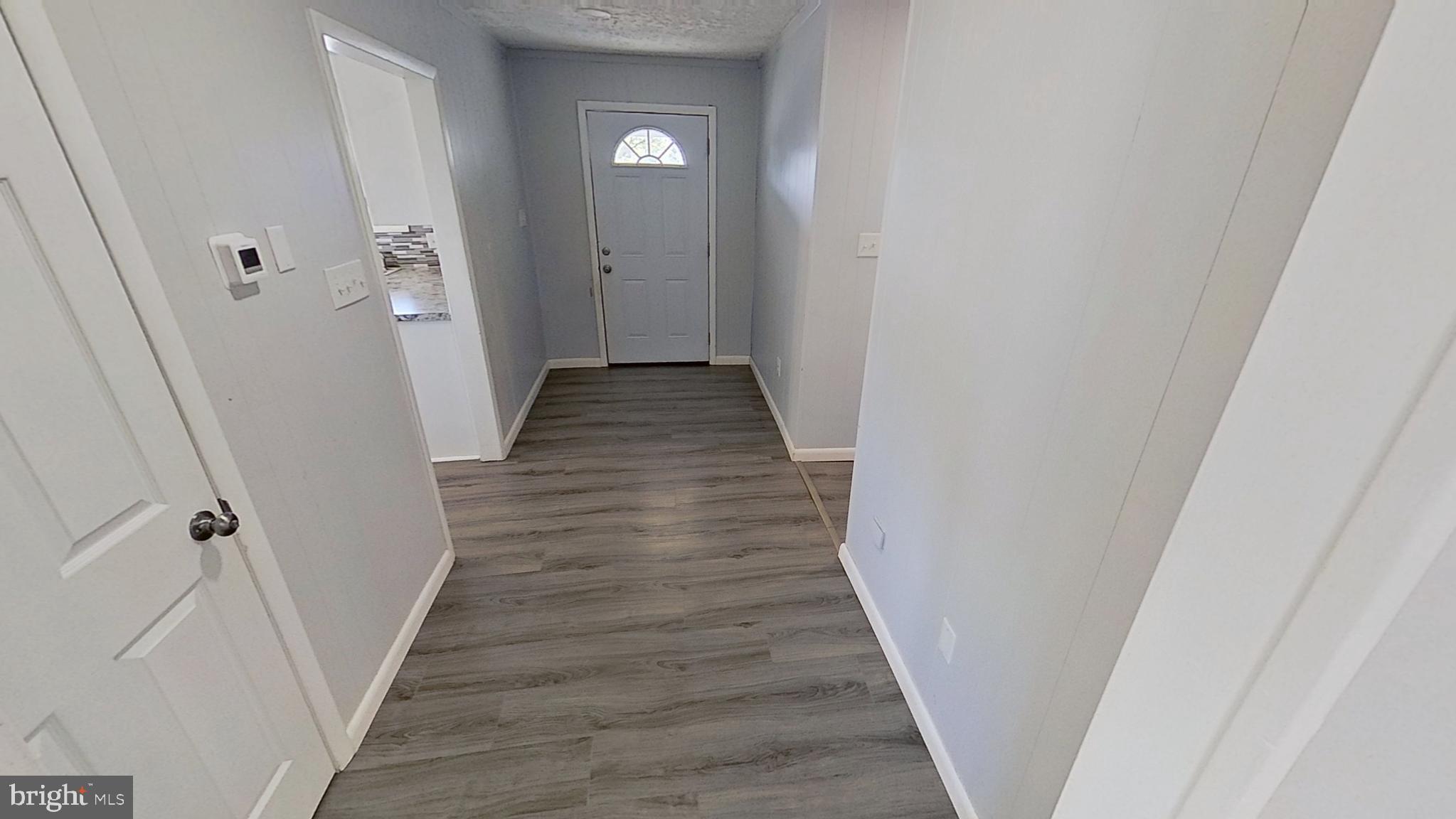 490 Windsor Street, Unit B Red Lion, PA 17356 - Photo 2 of 15 a view of a hallway with wooden floor and staircase