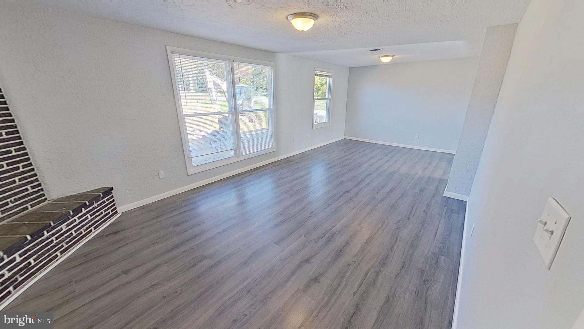 490 Windsor Street, Unit B Red Lion, PA 17356 - Photo 3 of 15 an empty room with wooden floor and windows
