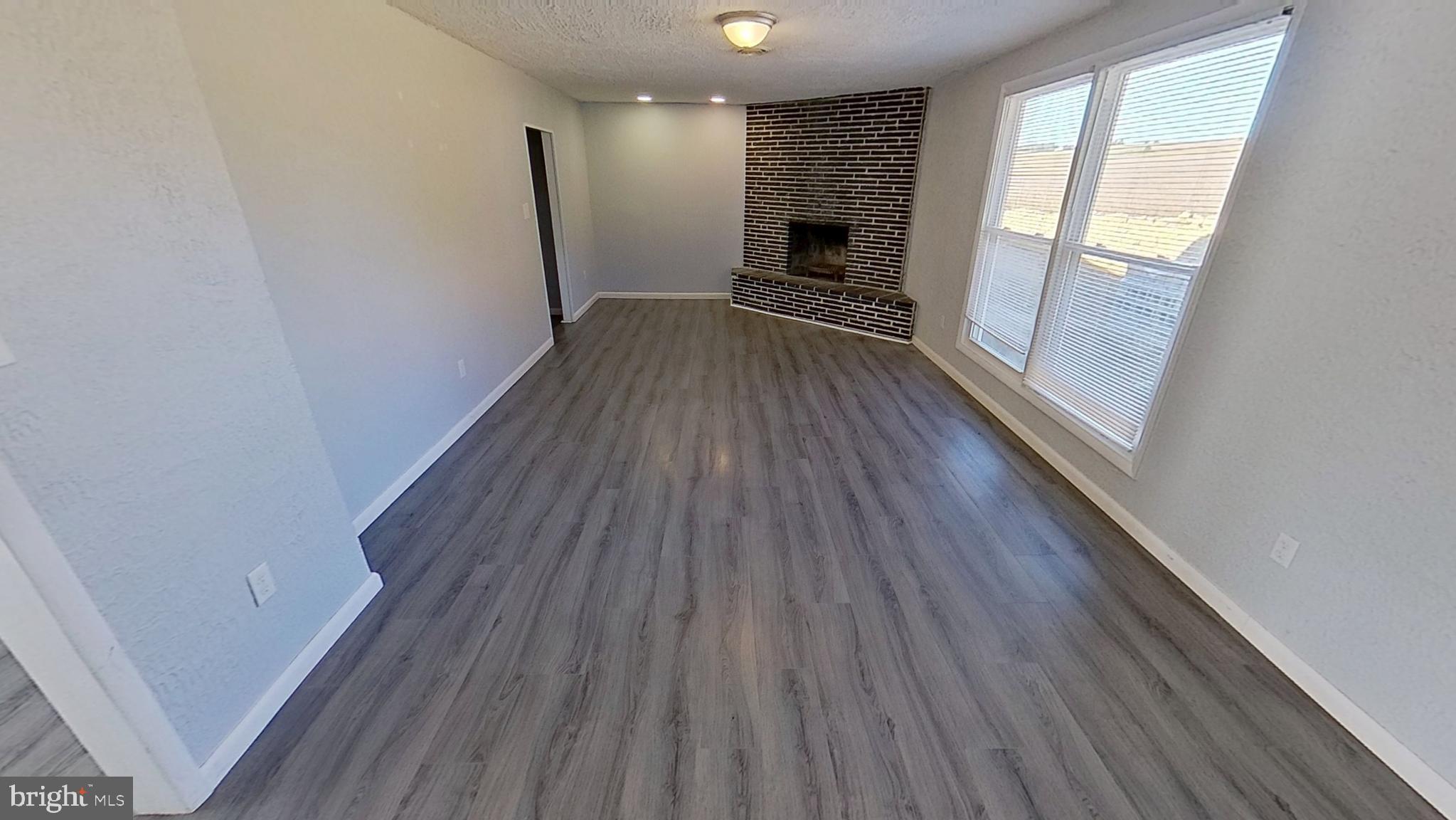 490 Windsor Street, Unit B Red Lion, PA 17356 - Photo 4 of 15 a view of empty room with wooden floor and fireplace