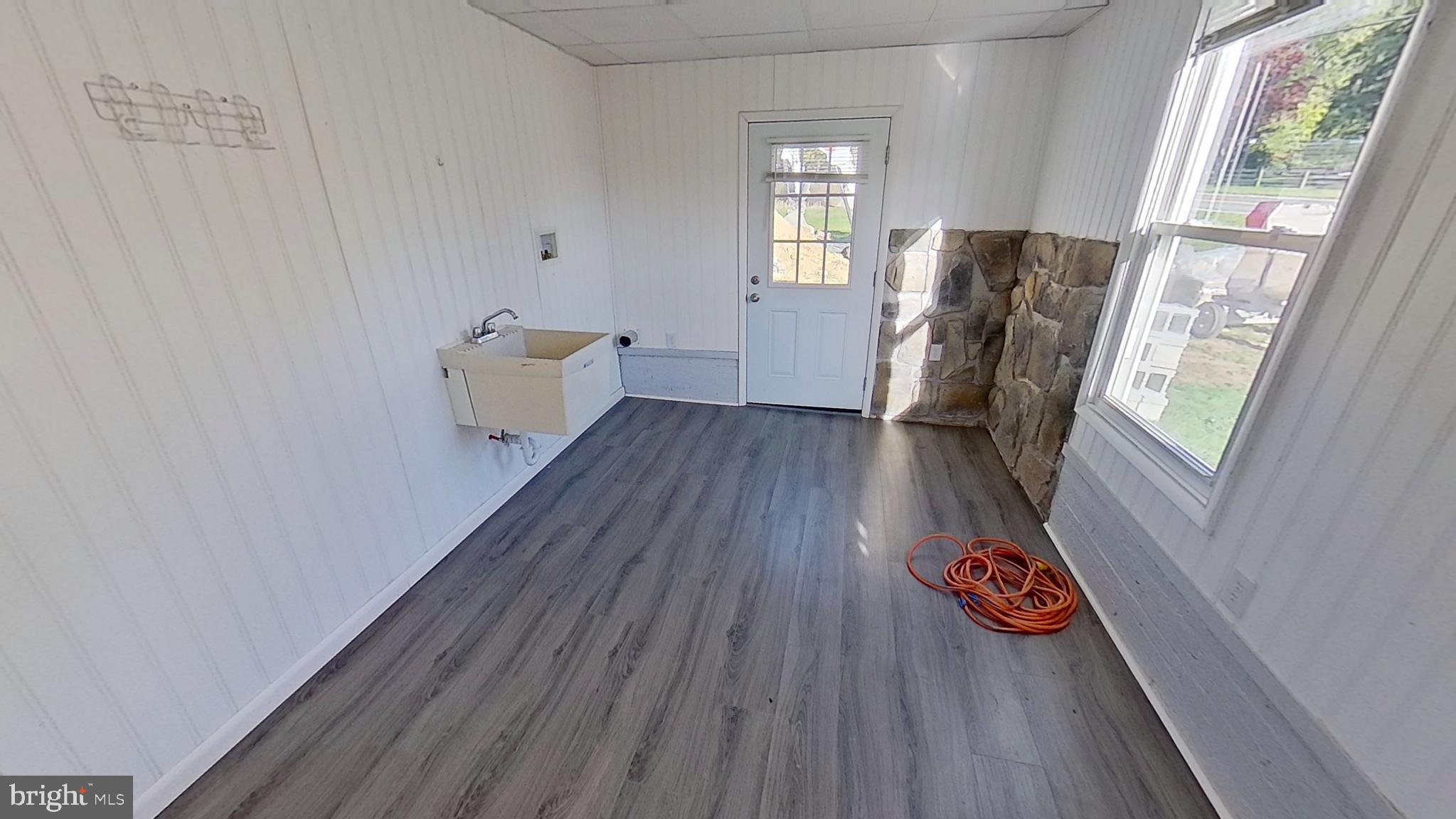 490 Windsor Street, Unit B Red Lion, PA 17356 - Photo 6 of 15 a view of an empty room with wooden floor and a window