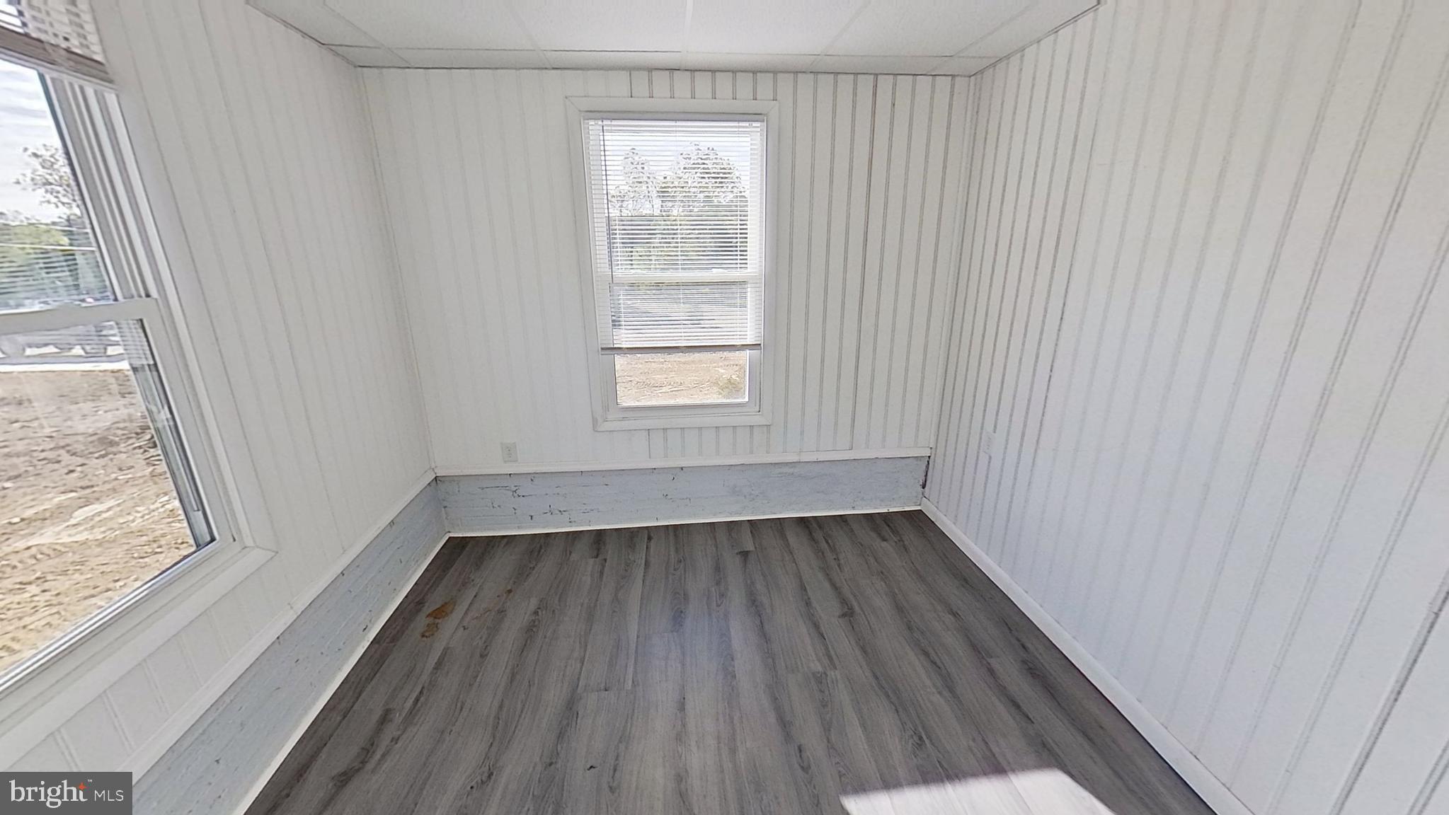 490 Windsor Street, Unit B Red Lion, PA 17356 - Photo 8 of 15 an empty room with wooden floor and windows