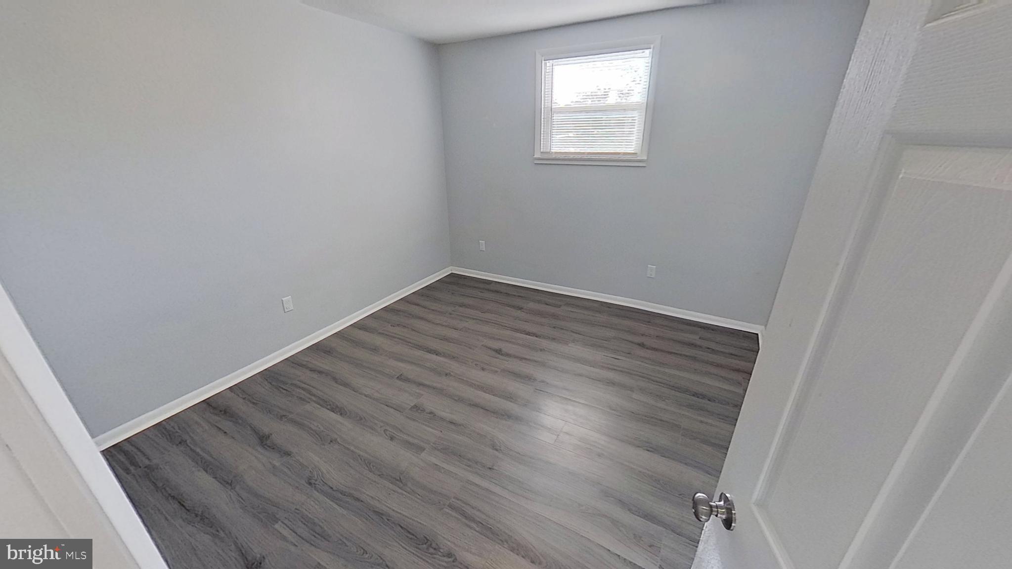 490 Windsor Street, Unit B Red Lion, PA 17356 - Photo 10 of 15 an empty room with wooden floor and windows