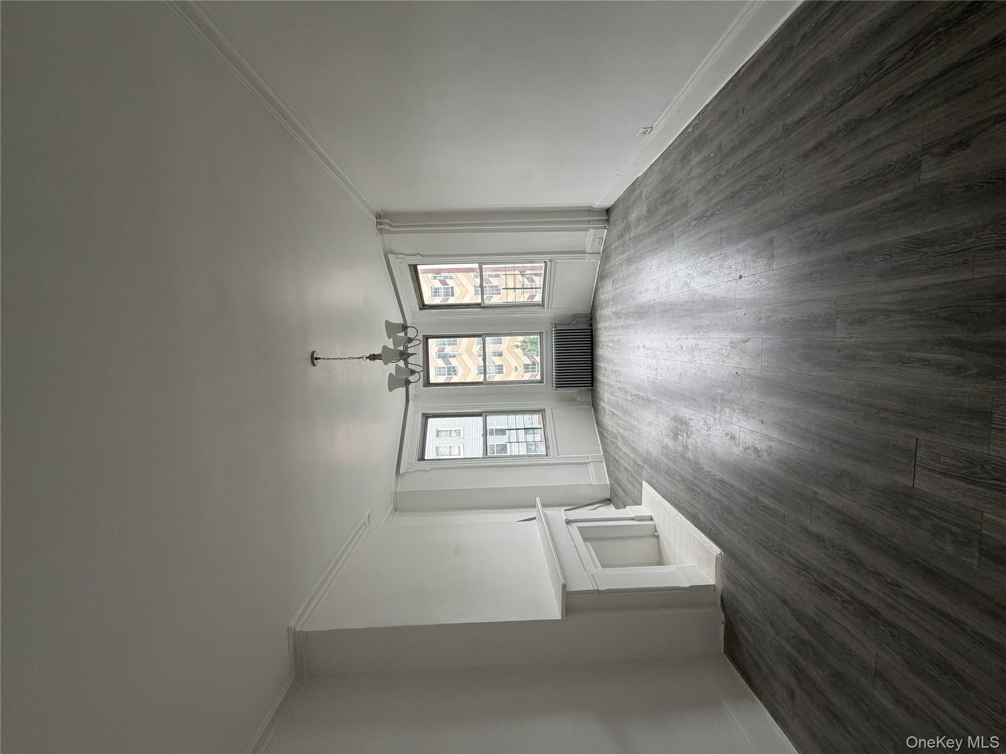 88 Cornelia Street Brooklyn, NY 11221 - Photo 5 of 8 an empty room with wooden floor and windows