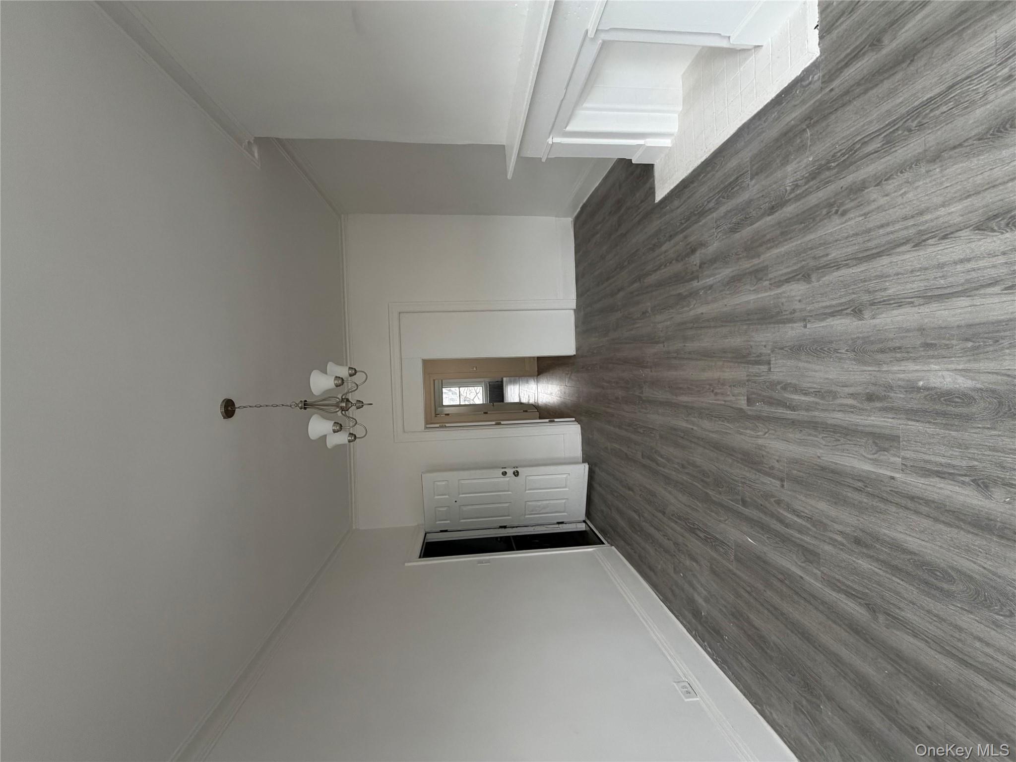 88 Cornelia Street Brooklyn, NY 11221 - Photo 6 of 8 wooden floor in an empty room with a window