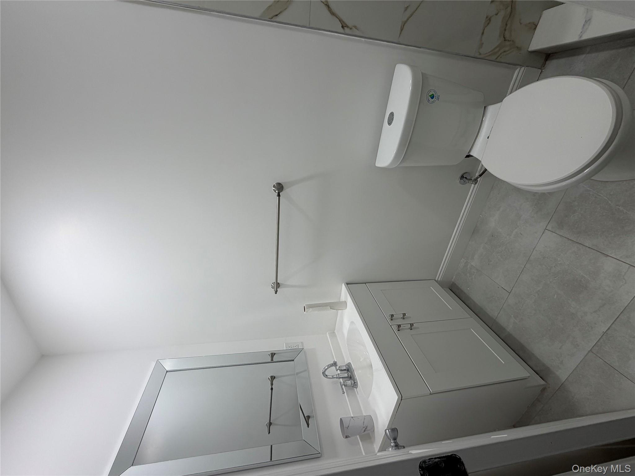 88 Cornelia Street Brooklyn, NY 11221 - Photo 8 of 8 a bathroom with a toilet sink and mirror
