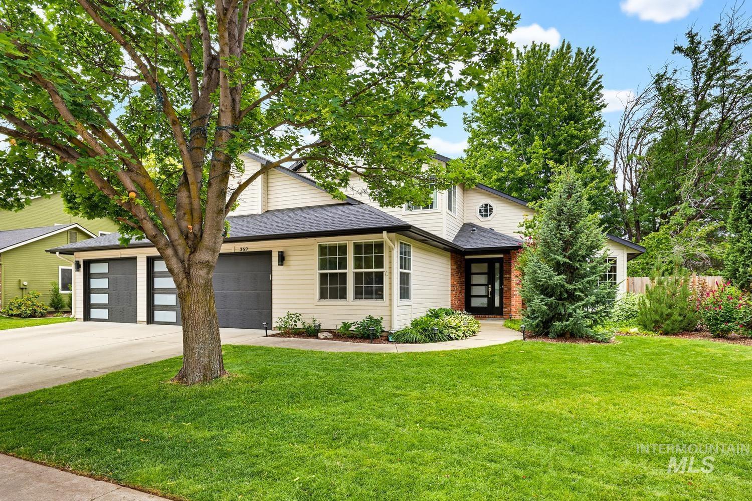 369 South Winthrop Way Boise, ID 83709 - Photo 1 of 50 Light-toned siding exterior with a dark shingle roof and a front entry featuring brick accents