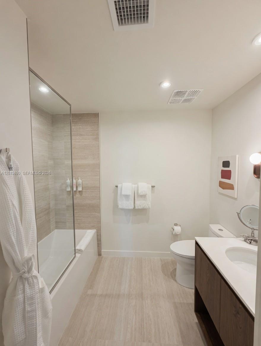 1611 Southwest 2nd Avenue, Unit 707 Miami, FL 33129 - Photo 4 of 9 a bathroom with a sink a toilet and shower