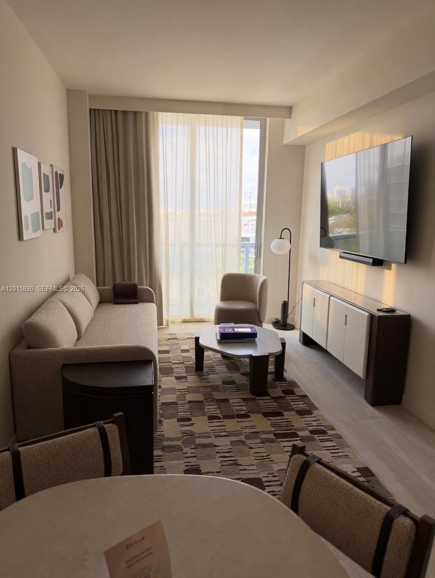 1611 Southwest 2nd Avenue, Unit 707 Miami, FL 33129 - Photo 5 of 9 a living room with furniture and a flat screen tv