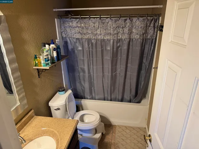 a bathroom with a toilet and shower