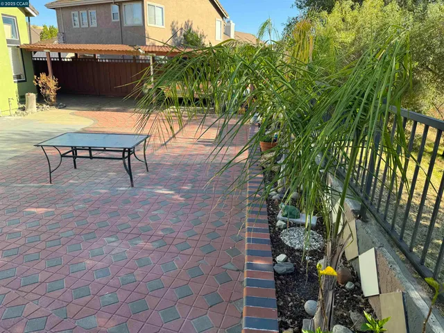 a backyard of a house with table and chairs