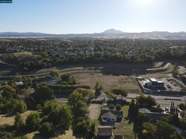an aerial view of residential building and lake