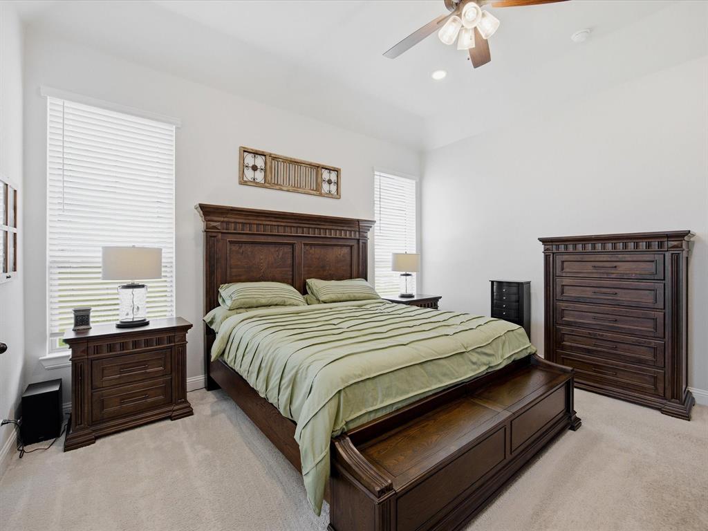 150 Quail Ridge Decatur, TX 76234 - Photo 19 of 32 a bedroom with a bed and a chandelier