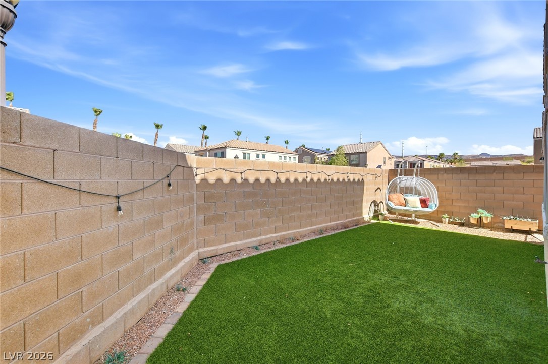 48 Jasmine Point Street Henderson, NV 89074 - Photo 54 of 62 A well-maintained yard offers a private retreat with artificial turf and durable block fencing.