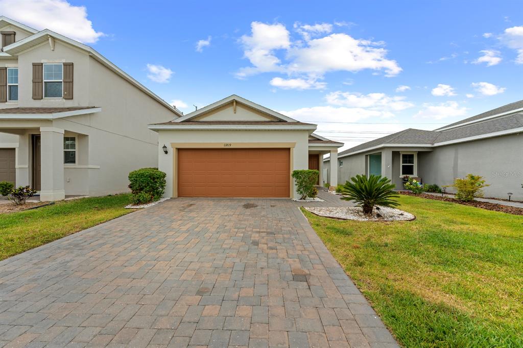 a front view of a house with a yard and garage